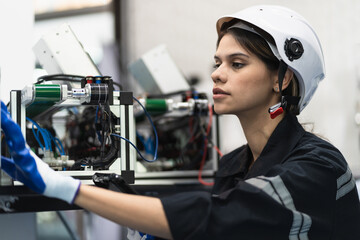 Engineer caucasian woman checking and repair electric machine in machine lap 