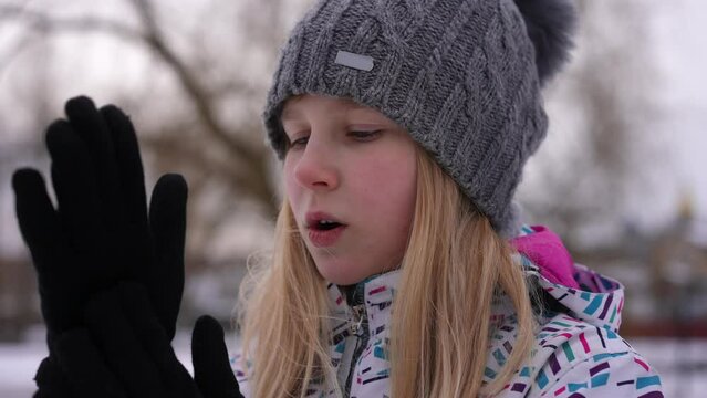 Teenage Freezed Girl Rubbing Hands Breathing Standing Outdoors On Cold Winter Day. Close-up Portrait Of Caucasian Teenager Waiting In Park On Cloudy Day