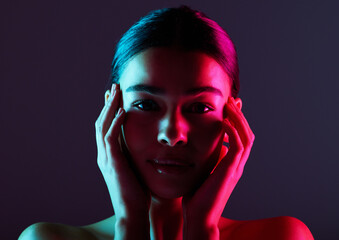 Beauty, neon shadow light and portrait of woman with dark lighting, facial cosmetics and skincare glow. Luxury studio makeup, aesthetic creativity and face model with creative pink blue color design