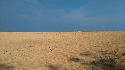 It is sea sand and clear blue sky