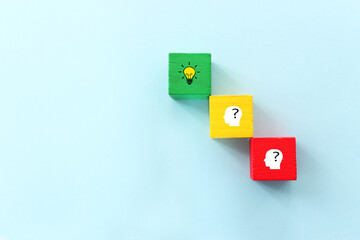Yellow bright light bulb and question mark over blue background