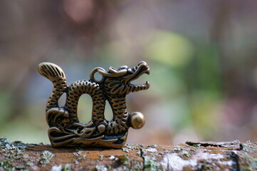 Dragon figurine close-up on a colored background. East Asian culture. A spiritual symbol.