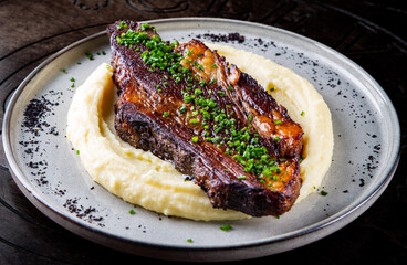 Beef brisket slice and mashed potato on white plate