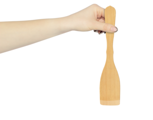 wooden kitchen spatula in hand isolated from background, concept of hand over or throw away wooden kitchen spatula