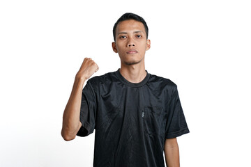 asian man wearing black training t-shirt, showing a strong stance with raised arms and muscles. Isolated by white background