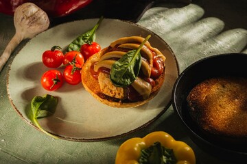 Still life: sandwich, vegetables on a dark green background. Homemade food