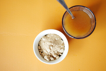 mixing brewers yeast flakes in a glass of water 