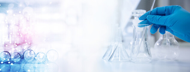 scientist in blue gloves with glass flask and test tube in research science lab banner background