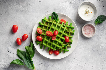 Green spinach waffles with tomato and greek yogurt. homemade healthy breakfast. top view