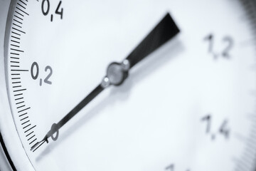 Pressure gauge close-up. Arrow of pressure gauge shows zero on scale..