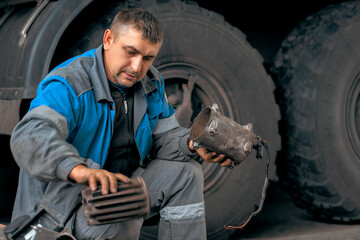 Auto mechanic repairs truck. Professional repair and diagnostics of cargo tractors and equipment....
