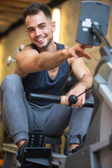 Fototapeta na wymiar confident exercise on rowing machine