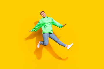 Fototapeta na wymiar Full body photo of carefree pretty lady jumping good mood free time isolated on yellow color background