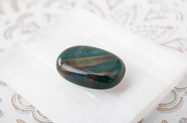 Close up view of semi precious stone heliotrope also known as bloodstone. Green gemstone with red...
