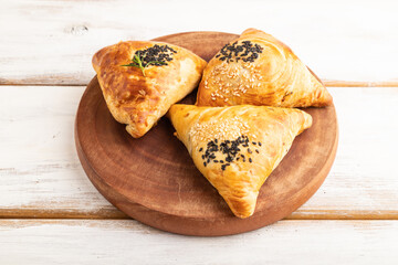 Homemade asian pastry samosa on white wooden. side view.