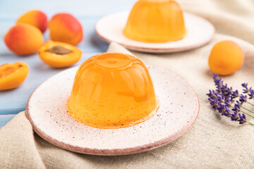 Apricot orange jelly on blue. side view, selective focus.