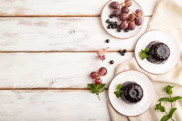Black currant and grapes jelly on white wooden. top view, copy space.