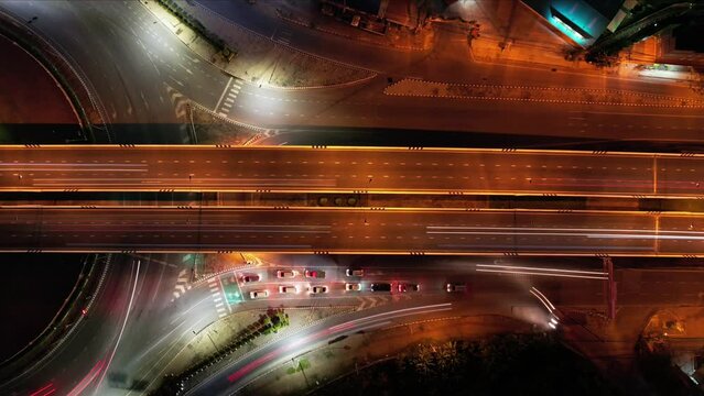 Traffic an important infrastructure, financial technology, Expressway top view, traffic transportation above intersection road in city night sky aerial view cityscape of advanced innovation,Hyperlapse
