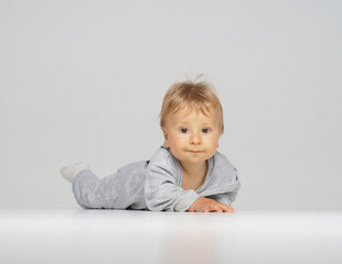 Little, happy and smiling cute baby in the studio. Portrait of a one year old baby. The concept of happiness.