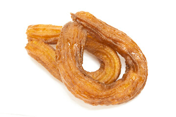 Traditional Turkish dessert (halka tatlı) on isolated white background. Turkish dessert deep fried and dipped in sugar syrup.