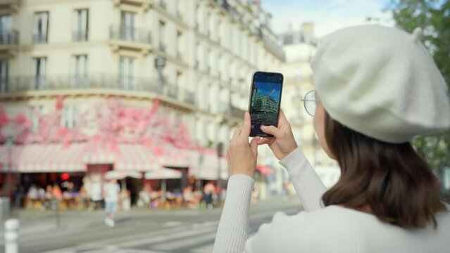 French blogger taking a photo of a street cafe