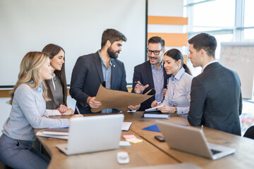 Group of young modern people in formal wear planning business strategy. Diversity engineers share...