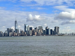 View of New york city, Manhattan from Liberty island, United states. Cinematic and panoramic new york cityscape with sea, clouds and skyscrapers. New York Cityscape . New York skyline