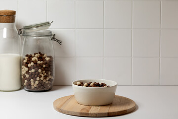 The concept of a healthy breakfast in white kitchen background. Cereals fin a bowl