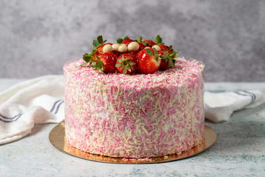 Fruit cake on a gray background. Strawberry, banana and chocolate birthday or celebration cake. Bakery desserts. close up