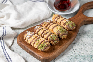 Chocolate, pistachio and coconut cookies on gray background. Bakery cookies assortment. Cookies with a cup of tea.Close up