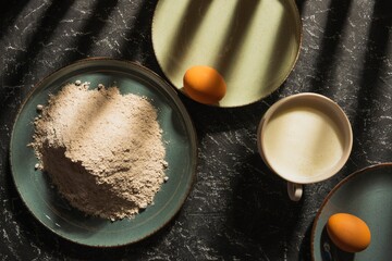 Still life - white flour in a dish on a dark background. Homemade slow food