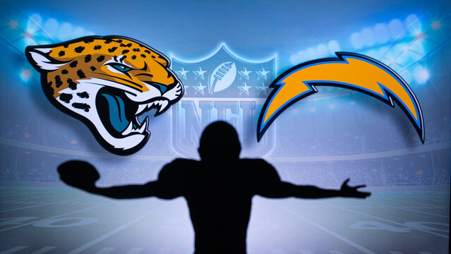 JACKSONVILLE, USA, JANUARY 10, 2023: Los Angeles Chargers vs. Jacksonville Jaguars. NFL Wild Card Round 2023, Silhouette of NFL player of american football. holding ball in hand. Big screen