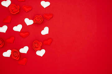 Red and white hearts and roses on a red background. Love concept, copy space, flat lay, place for text, banner, top view