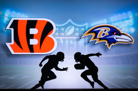 CINCINNATI, USA, JANUARY 10, 2023: Baltimore Ravens vs. Cincinnati Bengals. NFL Wild Card Round 2023, Silhouette of two NFL American Football Players against each other. Big screen in background