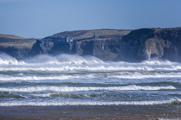 waves crashing below Dunluce Castle Causeway Coast Northern Ireland