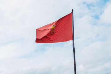 Flag of Navarra, Spain, waving in the wind on clear sky background.