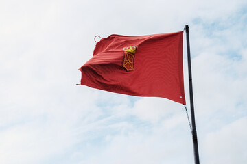 Naklejka na ściany i meble Flag of Navarra, Spain, waving in the wind on clear sky background.