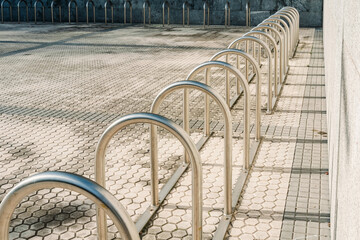 Bars to park  bicycles, empty, installed at the entrance of a building.