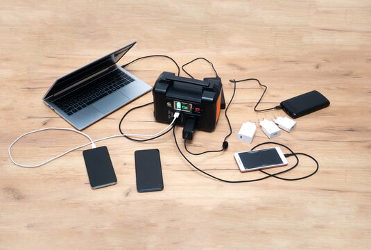 lithium Portable Power Station is charging laptop smartphones.Power banks and other gadgets..Modern, information technology.