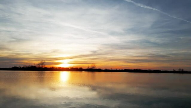 A sunset over the lake in the springtime