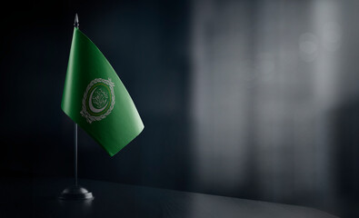 Small national flag of the Arab League on a black background