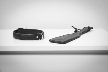 Paddle, collar on the table. Domestic discipline. Traditional corporal punishment implements. BDSM