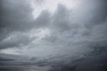 dark storm cloudy sky in rainy day with city building background 

