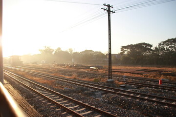 outside window railroad tracks in the countryside with sunset sky view	
