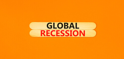 Global recession symbol. Concept words Global recession on wooden stick. Beautiful orange table orange background. Business and global recession concept. Copy space.