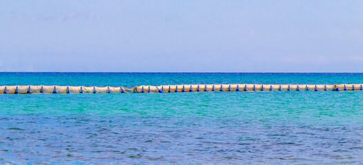 Blue water waves and ocean with buoy and ropes Mexico.