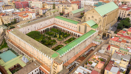 Aerial view of the Basilica of Santa Chiara, a religious complex in Naples, Italy. The building includes a church, a monastery, tombs, an archaeological museum and a cloister with internal gardens. - obrazy, fototapety, plakaty