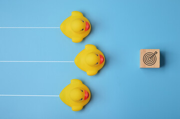 Toy ducks heading to the target. Ambition and challenge to achieve success concept.