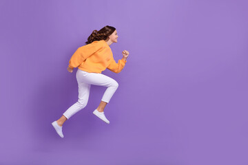 Full size profile portrait of excited crazy person jumping running empty space isolated on purple...