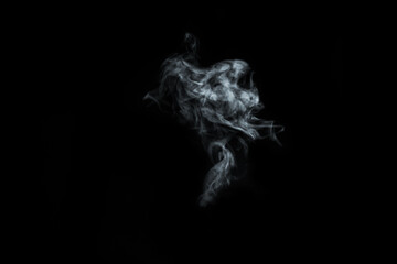 Close-up view of blue water vapor with spray from the humidifier Isolated on black background. steam smoke